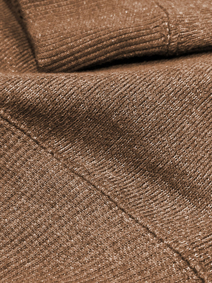 Close-up of terra brown ultra soft plush knit textured fabric with a folded pattern