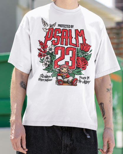 Person wearing a white t-shirt with a graphic design featuring 'Psalm 23' text and illustrations.