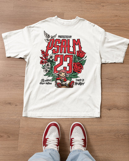White t-shirt with 'Protected by Psalm 23' design on a wooden floor