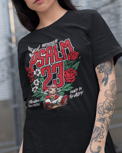 Person wearing a black t-shirt with 'Protected by Psalm 23' graphic design.